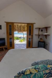 a bedroom with a bed and a view of the ocean at Casa Origen Boutique en San Bernardo del Viento in San Bernardo del Viento