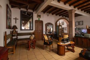 a living room with a cross on the wall at Hotel-Boutique La Casa De Los Recuerdos in Zitácuaro