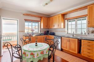 a kitchen with a table and chairs in a room at CASA LAVANDA - very nice stylish house in Caldas da Rainha
