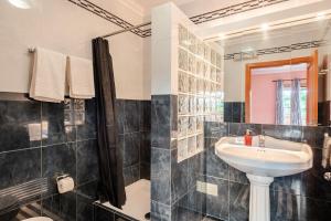 a bathroom with a sink and a mirror at CASA LAVANDA - very nice stylish house in Caldas da Rainha +42 photos