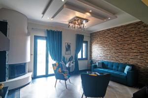 a living room with a blue couch and a brick wall at Koni Guesthouse in Kos