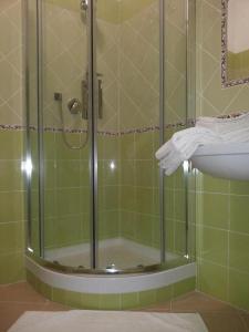 a shower with a glass door next to a sink at Il Giglio Marino GuestHouse in Gaeta