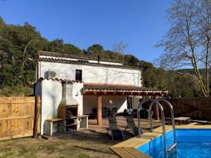 a house with a pool in front of it at Casa Rural Can Ricós - El Mirador del Montseny in Vallgorguina