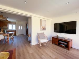 a living room with a large tv and a table at Ventura Beach by Best Holidays Fuerteventura in Corralejo