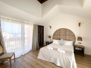 a bedroom with a large bed with towels on it at Ventura Beach by Best Holidays Fuerteventura in Corralejo +45 photos