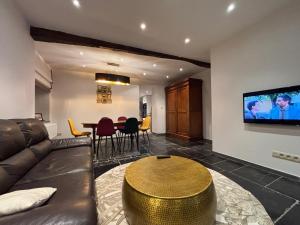 a living room with a couch and a table at La Maison de Lison in Furfooz