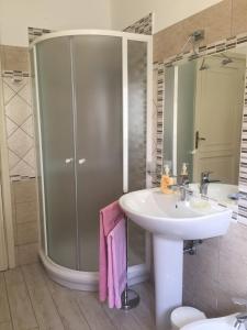 a bathroom with a sink and a shower at Abbratzu Guest House - Sardinian style and garden in Bosa