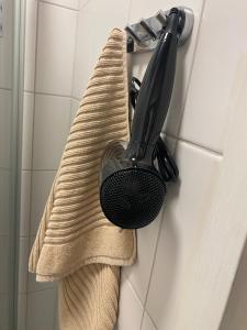 a towel is hanging on a wall with a black brush at Simply chic Kamppi !NEW! in Helsinki