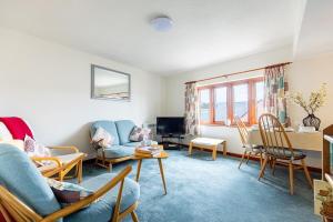 a living room with a couch and chairs and a table at KATHERINES COURT - Spacious Apartment with Rolling Hill Views in Kendal