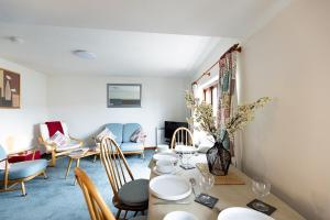 a living room with a table and chairs at KATHERINES COURT - Spacious Apartment with Rolling Hill Views in Kendal +15 photos