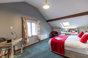 a bedroom with a bed and a desk and a window at KATHERINES COURT - Spacious Apartment with Rolling Hill Views in Kendal