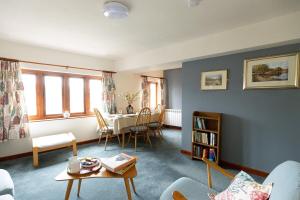 a living room with a table and a dining room at KATHERINES COURT - Spacious Apartment with Rolling Hill Views in Kendal