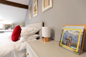 a bedroom with a bed and a table with a book at KATHERINES COURT - Spacious Apartment with Rolling Hill Views in Kendal