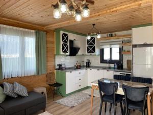 a kitchen and living room with a table and a couch at Demre Lukka Bungalow in Demre