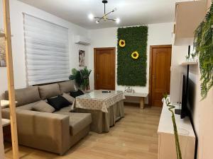 a living room with a couch and a table at White-Moon in Baena