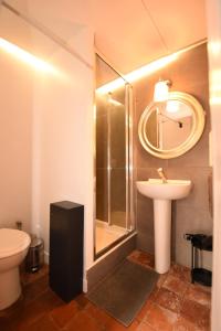 a bathroom with a sink and a shower and a toilet at Villa de charme entre deux baies in Rue +89 photos
