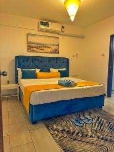 a blue bed in a bedroom with a rug at Nyali Luxury Apartments, Antalya in Mombasa +57 photos