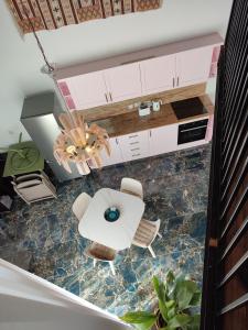 a kitchen with a table and chairs and a chandelier at Xlendistays - Centrally located Seafront living holiday spaces in Xlendi in Xlendi +101 photos