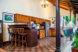 a kitchen with a table and chairs and a counter at Elegant, Romantic & Kid-Friendly Colonial Home in Granada