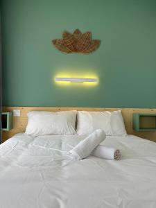a large white bed with a towel on it at Le D'Artagnan - App 11 - Balcon in Cazaubon