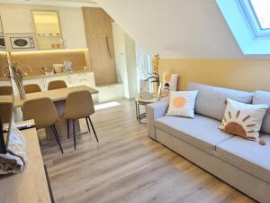 a living room with a couch and a kitchen at Mi Casa Sol in Mosonmagyaróvár