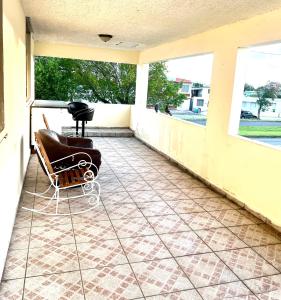 a porch with a couch and a chair on a balcony at Villa Vlad in Carolina