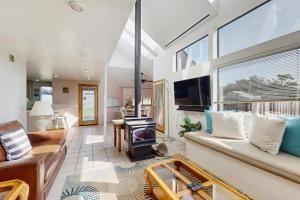 a living room with a couch and a fire place at One Eyed Jack's Retreat in Sea Ranch