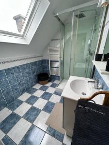 a bathroom with a sink and a glass shower at La maison du Distillateur in Plurien +30 photos