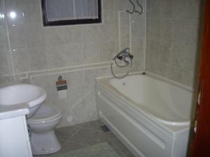 łazienka z białą wanną i toaletą w obiekcie Guest House Nada w mieście Sokobanja