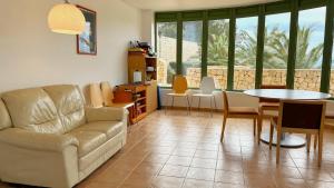 a living room with a couch and a table and chairs at Alcossebre Panorama Suite, Piscina y Terraza con Vistas in Alcossebre
