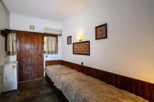 a room with a long couch on the wall at Oropos By the Sea in Markópoulon Oropoú +25 photos