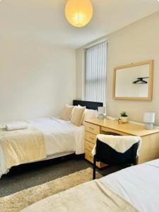a bedroom with two beds and a desk at Room 4 Shared House in L6 in Liverpool