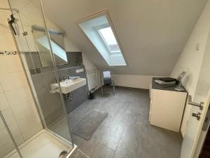 a bathroom with a shower and a sink at Melli‘s Seenahe Ferienwohnung in Langenargen +23 photos