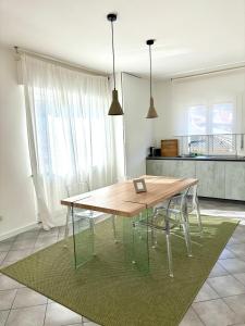 a dining room with a wooden table and chairs at Fortuna's quiet place in Riva del Garda