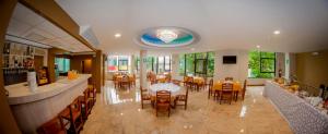 a dining room with tables and chairs in a restaurant at Hotel Europa in Iquitos