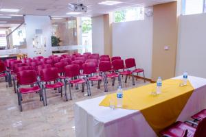 a conference room with red chairs and a table with two water bottles at Hotel Europa in Iquitos +44 photos