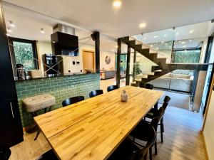 a dining room with a wooden table and chairs at Square house in Funchal