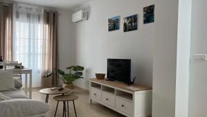 a living room with a tv on a dresser at La Tahona in Nerja