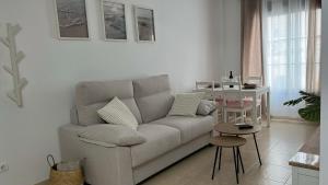 a living room with a couch and a table at La Tahona in Nerja