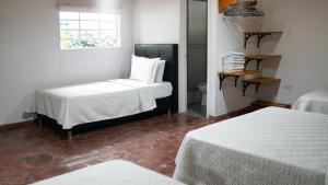 A bed or beds in a room at Hotel Diego Pacho