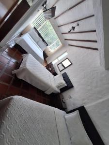 A bed or beds in a room at Hotel Diego Pacho