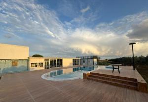 a building with a pool and a table on a deck at Happiness City in Iskele
