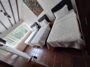 A bed or beds in a room at Hotel Diego Pacho
