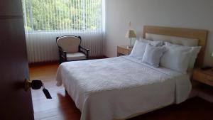 A bed or beds in a room at Hotel Diego Pacho