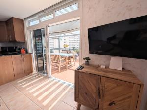 a kitchen with a large flat screen tv on a wall at Luxury & Panorama Apartment in Costa de Adeje