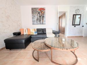 a living room with a black couch and a table at Luxury & Panorama Apartment in Costa de Adeje +16 photos