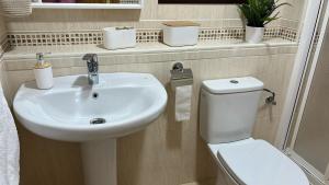 a bathroom with a white sink and a toilet at La Tahona in Nerja +9 photos