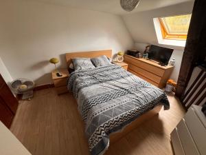 a bedroom with a bed and a television in it at Appartement à louer in Longueil-Sainte-Marie