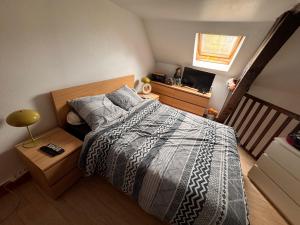 a bedroom with a bed with a wooden head board at Appartement à louer in Longueil-Sainte-Marie
