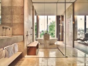 a bathroom with a tub and a sink at Conservatorium Hotel in Amsterdam